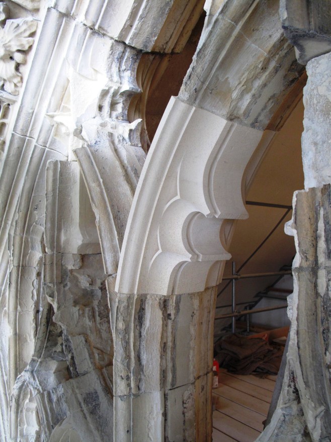 New stonework indented into existing window arches