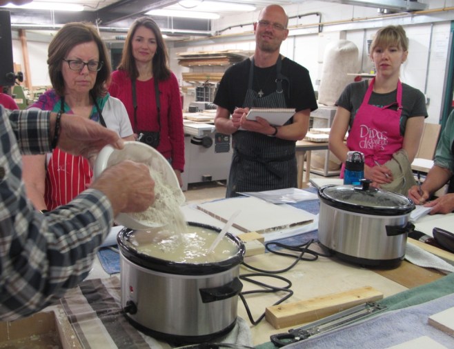 Dylan Hartley demonstrating hown to mix gesso in slow cooker