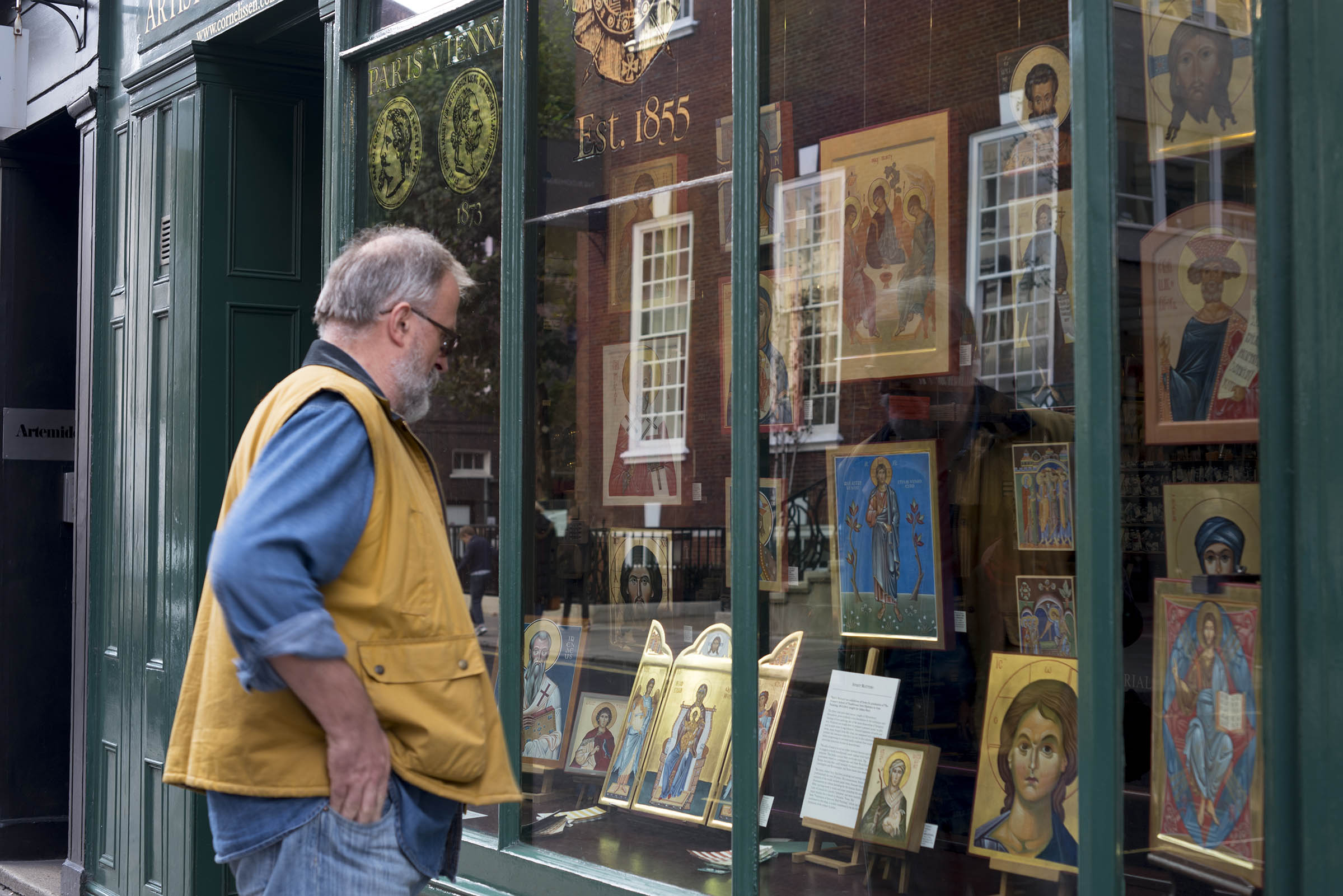 man looking in window of Cornelissens